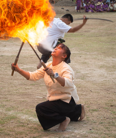 Lamphun, Thailand - April 12, 2019: Female perform fire breathing on Songkran festival in Lamphun provinceのeditorial素材