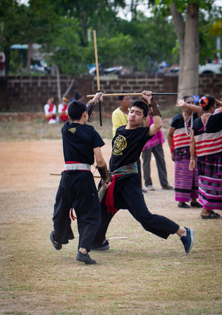 Lamphun, Thailand - April 12, 2019: Men perform martial art with stick in Lanna Northern style on Songkran festival in Lamphun provinceのeditorial素材
