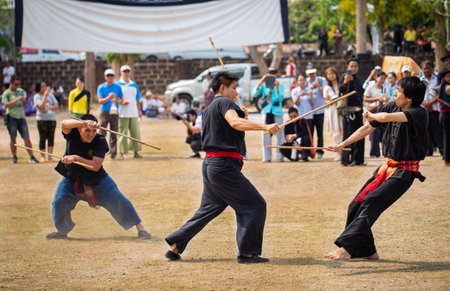 Lamphun, Thailand - April 12, 2019: Men perform martial art with stick in Lanna Northern style on Songkran festival in Lamphun provinceのeditorial素材