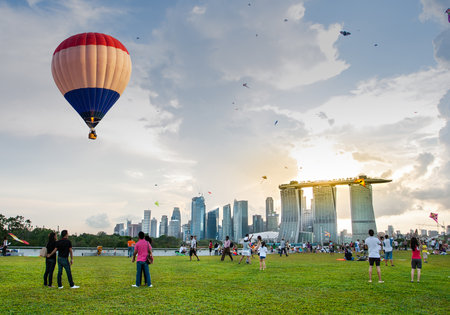 Marina Bay, Singapore - October 4, 2014: Aerial view of hot air balloon flying over Marina Barrage. scenic view of cityscape of Singapore with sunset in background.のeditorial素材