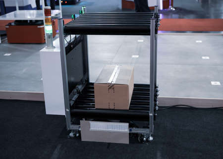 Industry shuttle robot carry carton in modern warehouse factory. Automated guided vehicle AGV.の写真素材