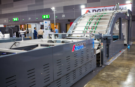Bangkok, Thailand - September 22, 2023: automatic high speed cardboard laminating machine display in...