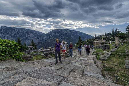 Delphi, Phocis / Greece - October 22, 2012: Tourists following the Sacred Way in the archaeological site of Delphiのeditorial素材