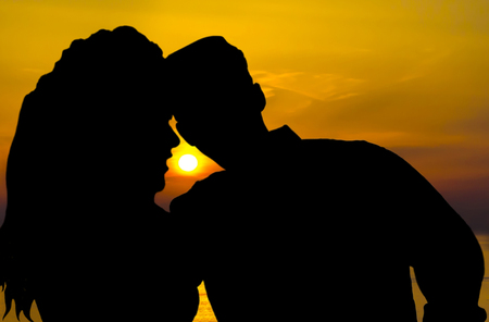 Young couple in love at sunset timeの写真素材