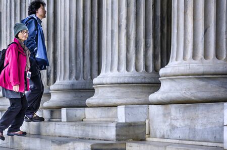 Athens, Attica / Greece. A couple of Asian tourists visiting the Zappeion Hall neoclassical building...