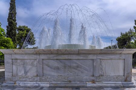 Athens City, Attica / Greece - May 20, 2019: Close up view of the marble fountain gushing water in front of the Zappeion Hall neo-classical building in the National Garden park near Syntagma Squareのeditorial素材