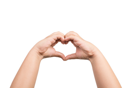 Close up of heart made by children hands isolated on white backgroundの写真素材