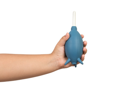 child hand holding a rubber air blower pump dust cleaner isolated on white backgroundの写真素材