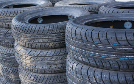 Old used tires stacked  background