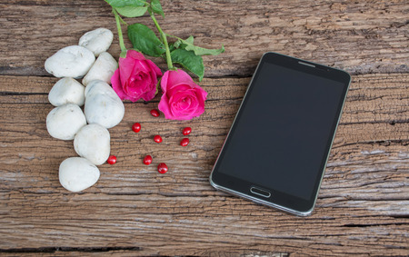 Smart phoneon on old wooden backgroundの写真素材