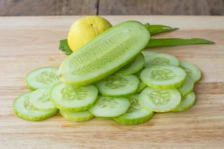 slices of lemon and cucumber on wooden backgroundの写真素材