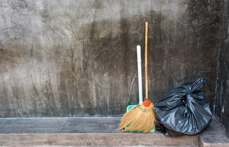 Broom For Floor Dust Cleaning and Black Plastic Garbage Bagの写真素材