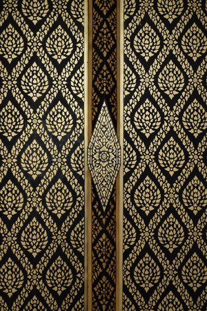 The pattern on the door Watbanghuasuea written with gold dust. Thailand decorative arts.の写真素材