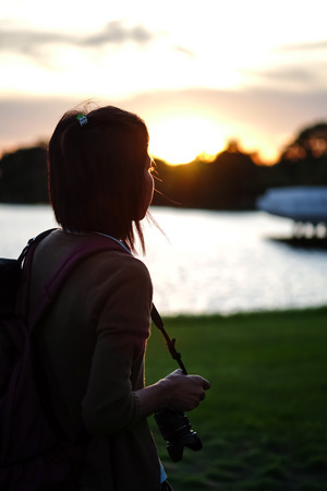 the women was standing at sunsetの写真素材