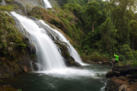 CHANTHABURI, THAILAND - NOVEMBER 29, 2017: Tourist standing see the waterfall 9th floor. Waterfall in the forest. Thailand waterfall in Chanthaburi (Khao Soi Dao Waterfall)のeditorial素材
