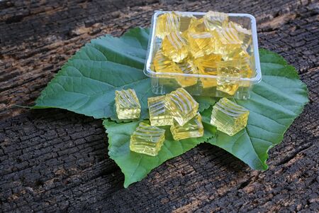 Sweet honey jelly in green leaves with woodenの写真素材