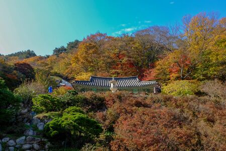 GYEONGJU, SOUTH KOREA, NOVEMBER 1, 2017. People visit Seokguram Grotto (which contains a Buddha image) on an autumn day with colorful trees surrounding the site.のeditorial素材