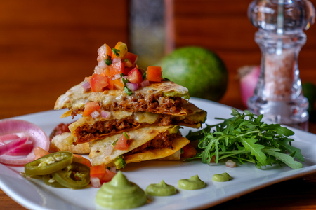 Mexican quesadillas  with cheese, vegetables and salsaの写真素材