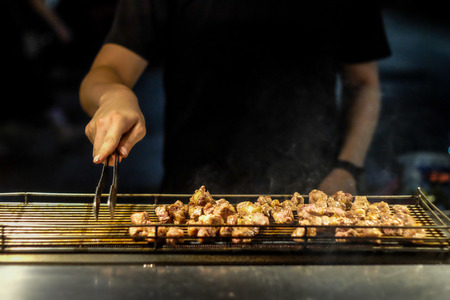 Grilling meat at Shilin Night Market in Taipei Taiwan.の写真素材