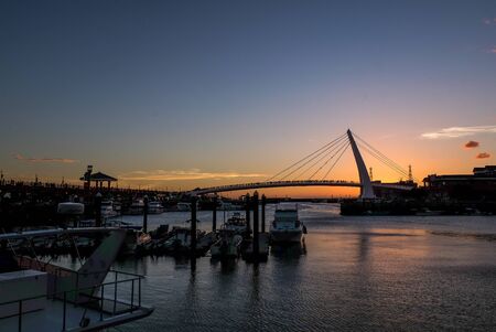 TAIPEI, TAIWAN - JULY 16, 2018 : Twilight of Tamsui fisherman's wharf and the famous lover's bridge where couples visit to view the sunsetのeditorial素材