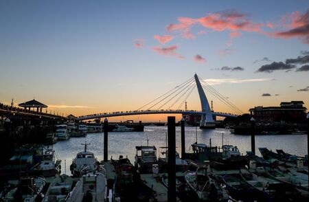 TAIPEI, TAIWAN - JULY 16, 2018 : Twilight of Tamsui fisherman's wharf and the famous lover's bridge where couples visit to view the sunsetのeditorial素材