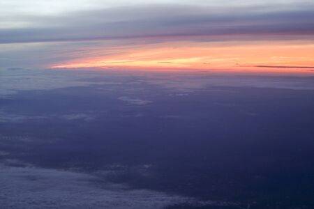 Beautiful sunrise above clouds from airplane perspective.の写真素材