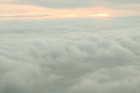 Beautiful sunrise above clouds from airplane perspective.の写真素材