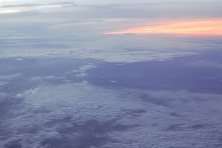 Beautiful sunrise above clouds from airplane perspective.の写真素材