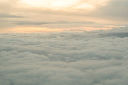 Beautiful sunrise above clouds from airplane perspective.の写真素材