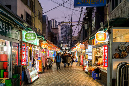 Busan, South Korea - April 3 , 2019 : Tourist walking at haeaundae traditional market street with various shops and seafood restaurants .のeditorial素材