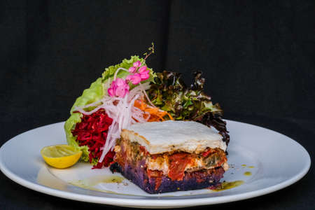 Lasagne base on baked sweet potato layers with ratatouille and bechamel gratinの写真素材