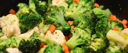 Steamed vegetables: broccoli, carrots and cauliflower in the pan.の写真素材