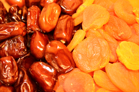 Dried fruits: delicious dates and dried apricots closeupの写真素材