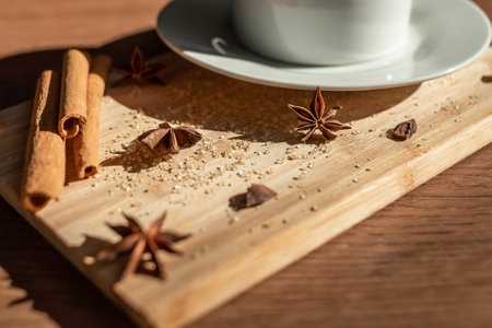 A cup of coffee with cane sugar and cinnamon sticksの写真素材