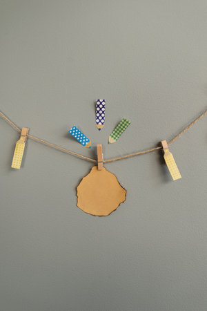 Stickers on the wall for notes. Hanging on a rope, on a clothespin, suitable for inscriptionsの写真素材