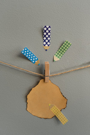 Stickers on the wall for notes. Hanging on a rope, on a clothespin, suitable for inscriptionsの写真素材