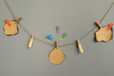 Stickers on the wall for notes. Hanging on a rope, on a clothespin, suitable for inscriptionsの写真素材