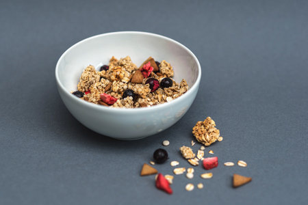 A bowl of muesli on a gray monochrome background, healthy food, healthy breakfastの写真素材