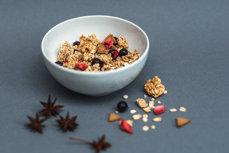 A bowl of muesli on a gray monochrome background, healthy food, healthy breakfast