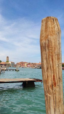 Sea view, wooden bridge and pillars at the sea pier, Venice, Italyの写真素材