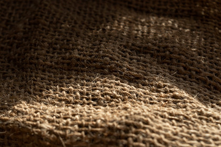 Texture of natural burlap material close-up, with natural folds and draperiesの写真素材