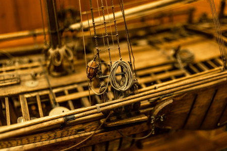 Wooden ship model close-up, mast, guns, cables - details of a frigate toy modelの写真素材