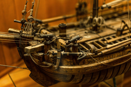 Wooden ship model close-up, mast, guns, cables - details of a frigate toy model
