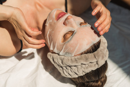 Face and body treatments. The concept of maintaining health, youth and beauty. Face masks, modern cosmetology, beautician, hands. beauty techniques.の写真素材