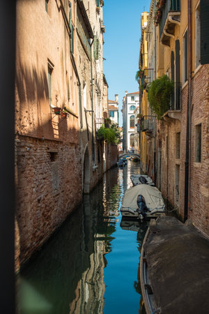 View of the Venetian canal with boats and old houses in flowers. A tourist place, a journey. Venice, Italy, 08.19.2023のeditorial素材