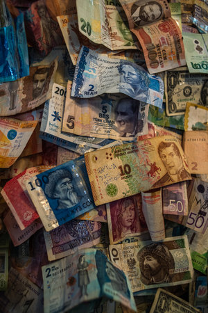 Background of banknotes from different countries of the world. Lots of colorful paper money top viewのeditorial素材