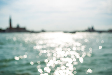 Background with highlights of bokeh. Blue background, with highlights playing on the water. Blurred abstract backgroundの写真素材