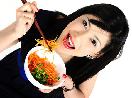 Beautiful young asian girl eating saladの写真素材