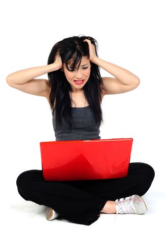 Young asian woman angry with her computerの写真素材