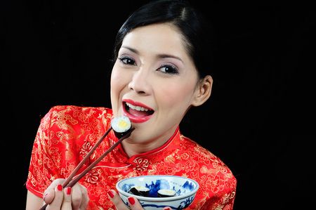 Beautiful young asian girl eatingの写真素材